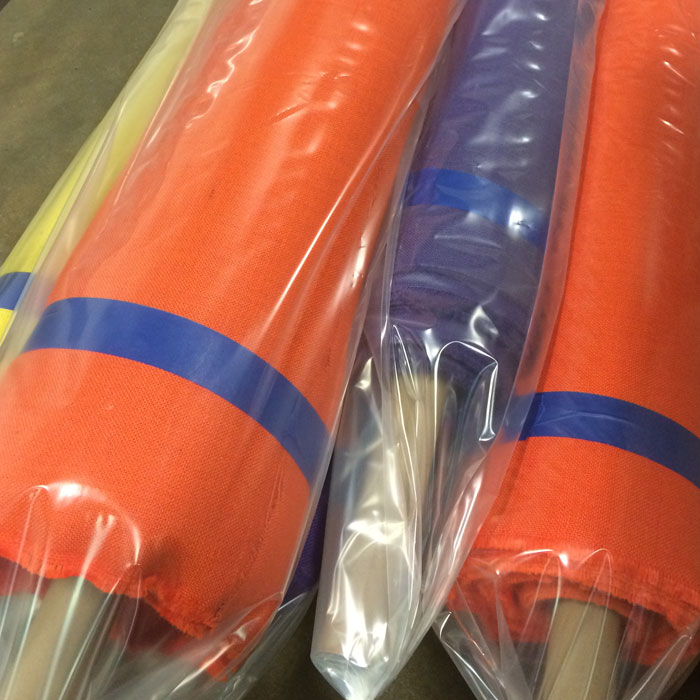 Flameproofing rolls of fabric